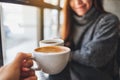 A woman and a man clinking coffee mugs in cafe Royalty Free Stock Photo