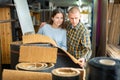 Woman and man consumer choosing carpet in hardware store Royalty Free Stock Photo