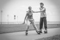 Woman and man couple rollerskates outdoor