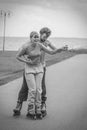 Woman and man couple rollerskates outdoor