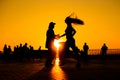 Woman and man couple silhouettes dancing against warm sunset orange sky Royalty Free Stock Photo