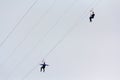 Woman and a man descend on a rope against the sky. reme Sports