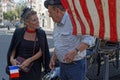 Woman and man discuss under a US flag