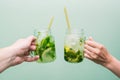 Woman and man drinking a cocktail. Friends relax at a party or club, celebrate and relax, holding fruit drinks in their hands.