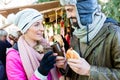 Woman and man eating and drinking on Christmas market Royalty Free Stock Photo