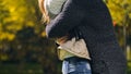 Woman and man embracing in autumn park, meeting after long time parting, love Royalty Free Stock Photo