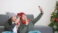 Woman and man funny making taking selfie together with smartphone