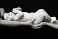 Woman and man hands holding a newborn. Mom, dad and baby. Close-up Royalty Free Stock Photo