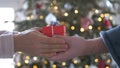 Woman and man hands holding red gift box presents with silver ribbon bow. Concept Season of giving, Christmas, happy new Royalty Free Stock Photo