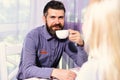 Woman and man with happy face have a date. Couple in love holds cups of coffee at table Royalty Free Stock Photo