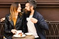 Woman and man with happy faces have date at cafe. Royalty Free Stock Photo