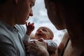 Woman and man holding on hands a newborn. On the background window. Mom, dad and baby. Portrait of young family. Happy family life Royalty Free Stock Photo