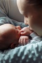 Woman and man holding on hands a newborn. Mother kissing her son. Portrait of young family. Happy family life. Man was born Royalty Free Stock Photo