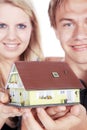 Woman and man holding a miniature house Royalty Free Stock Photo