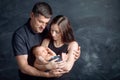 Woman and man holding a newborn. Mom, dad and baby. Close-up. Portrait of  smiling family with newborn on the hands. Happy family Royalty Free Stock Photo