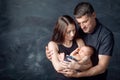 Woman and man holding a newborn. Mom, dad and baby. Close-up. Portrait of  smiling family with newborn on the hands. Happy family Royalty Free Stock Photo