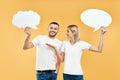 Woman and man holding paper thought bubbles