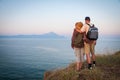 Woman and man hugging on the top of the mountain in the sunset