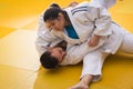 Woman and man judo fighters in sport hall