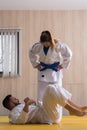 Woman and man judo fighters in sport hall Royalty Free Stock Photo