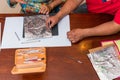 Woman and man making a metal embossed frame