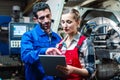 Woman and man manufacturing worker in discussion