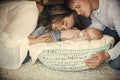 Woman, man and newborn child sleep in crib on floor Royalty Free Stock Photo