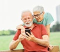 woman man outdoor senior couple happy lifestyle retirement together love fun elderly active mobile smartphone Royalty Free Stock Photo