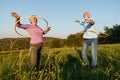 woman man outdoor senior couple happy retirement together smiling love spinning hoop exercise mature Royalty Free Stock Photo