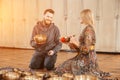 Woman and man playing on a tibetian singing bowl for sound therapy sitting in yoga studio. Sun light effect Royalty Free Stock Photo