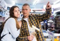 Woman and man points his hand at something in hardware store Royalty Free Stock Photo