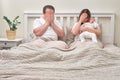 A woman and a man with problems after the birth of a newborn baby on the bed. Father and mother with a child boy, sad parents and Royalty Free Stock Photo
