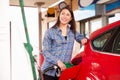 Woman man refuelling a car at a petrol station