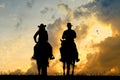 Woman and man ride horses at sunset Royalty Free Stock Photo