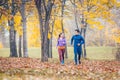 Woman and man running in autumn park for sport Royalty Free Stock Photo