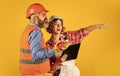 Woman and man safety hard hat. Redevelopment of home. Couple look documents. Couple planning changes renovation Royalty Free Stock Photo