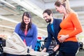 Woman, man, and sales lady in baby store Royalty Free Stock Photo