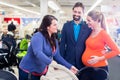 Woman, man, and sales lady in baby store Royalty Free Stock Photo