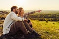 Woman and man sitting during summer hike talking