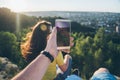 Woman with man sitting on the top of the hill injoy view on sunset