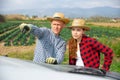 Woman and man standing near car and pointing to something Royalty Free Stock Photo