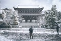 Woman and man taking photo japanese temple with her smartphone and his digital camera.