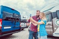 Woman and man taking selfie in front of RV or camper in anticipation