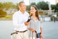 Woman and man using phone to book accommodations while travelling Royalty Free Stock Photo