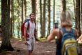 Woman and man using smartphone at forest,Adventure, travel, tourism, hike and people concept Royalty Free Stock Photo