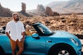 A woman and a man wearing glasses in a convertible car on a trip to the island of Tenerife. The crater of the Teide volcano, Royalty Free Stock Photo