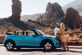 A woman and a man wearing glasses in a convertible car on a trip to the island of Tenerife. The crater of the Teide volcano, Royalty Free Stock Photo