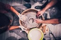 Woman and man working on the potter& x27;s wheel. Top view of hands making ceramic work Royalty Free Stock Photo