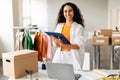 Woman Manager At Clothing Store Holding Clipboard Standing Near Table Royalty Free Stock Photo