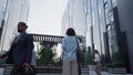 Woman manager standing in downtown area before work in morning. Rear view. Royalty Free Stock Photo